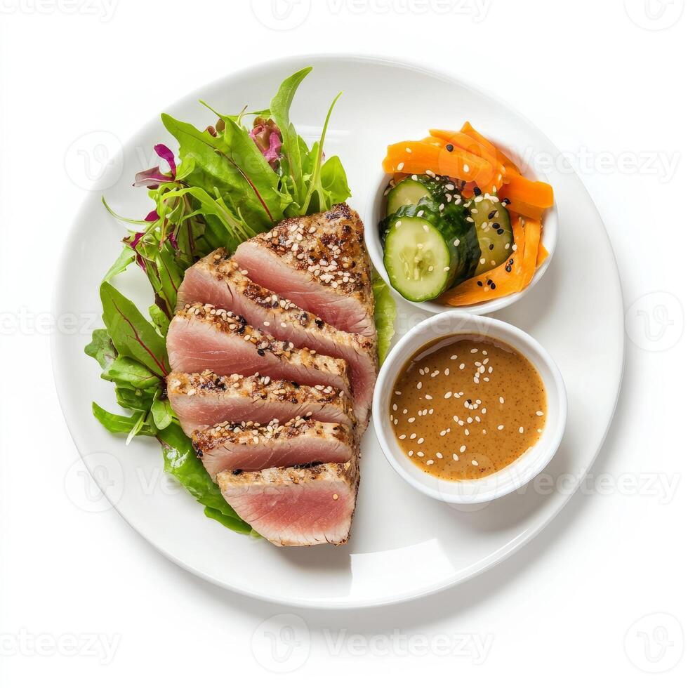 A meticulousy composed plate of seared tuna steak, served with a side of sesame-ginger sauce and photo