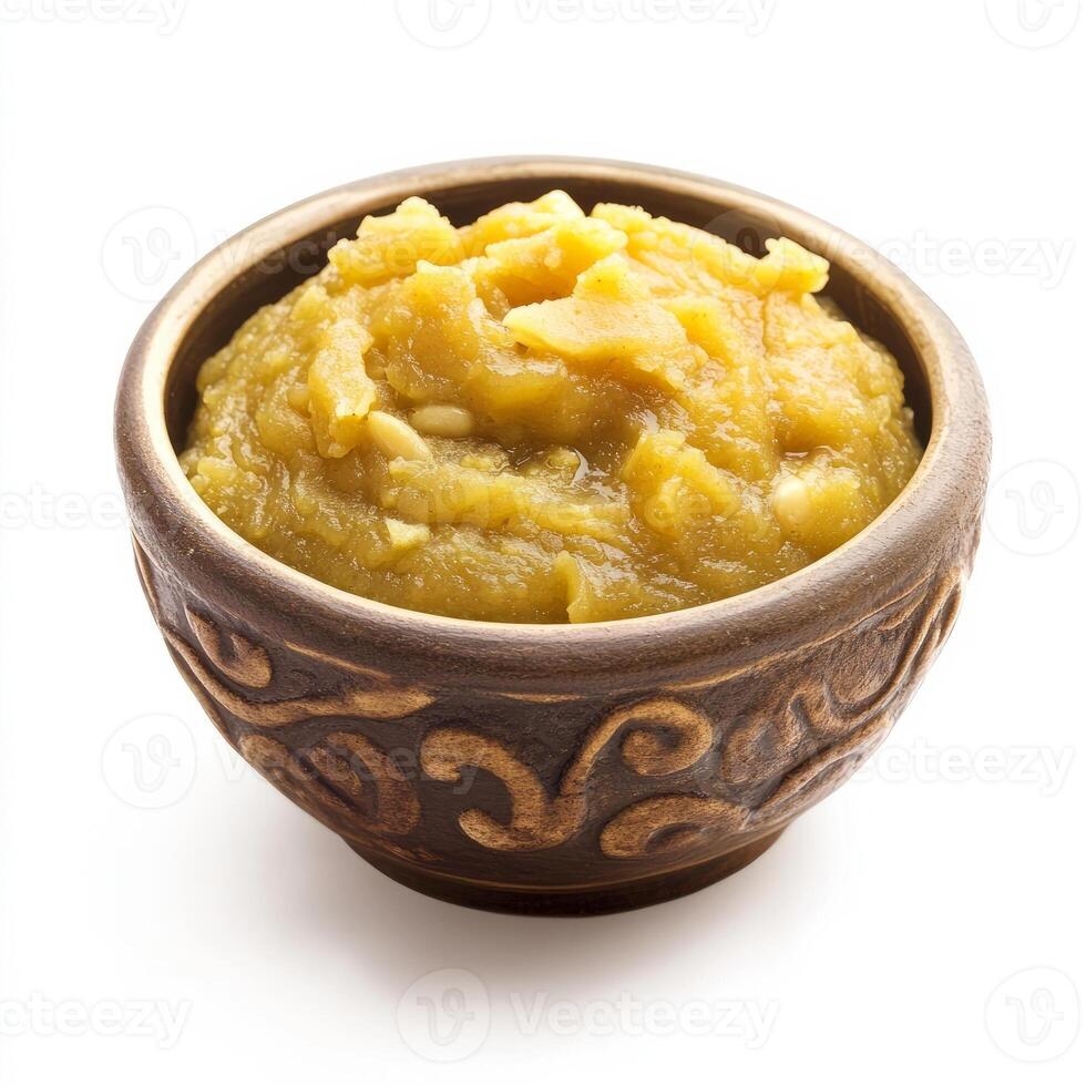 A bowl of yellow mustard on a white background photo