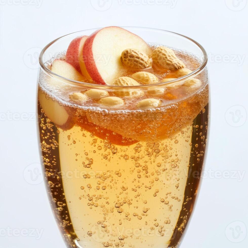 A glass of sparkling apple cider with nuts photo