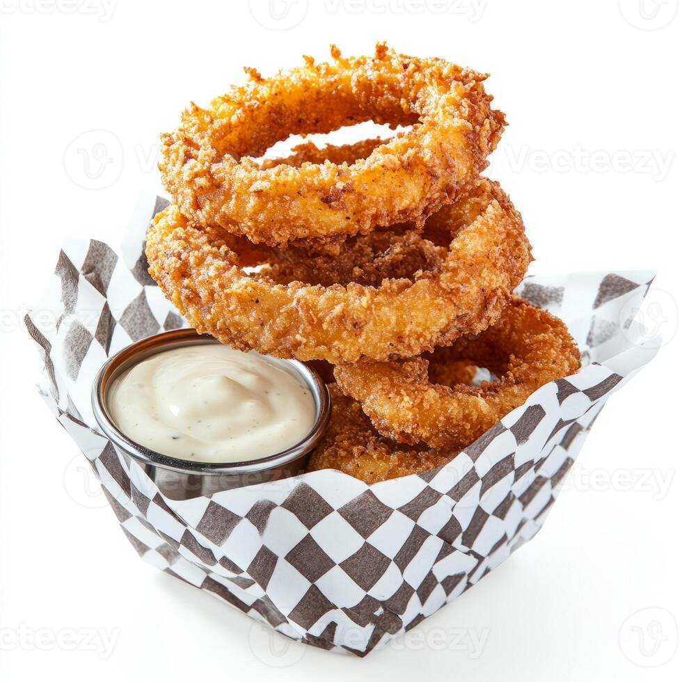 A stack of crispy, golden-brown onion rings, served with a side of creamy dipping sauce, resting on photo
