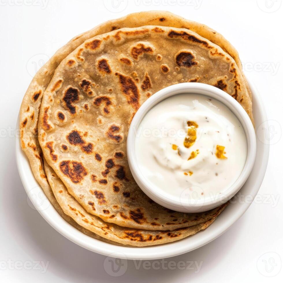 A bowl of yogurt and two flatbreads photo