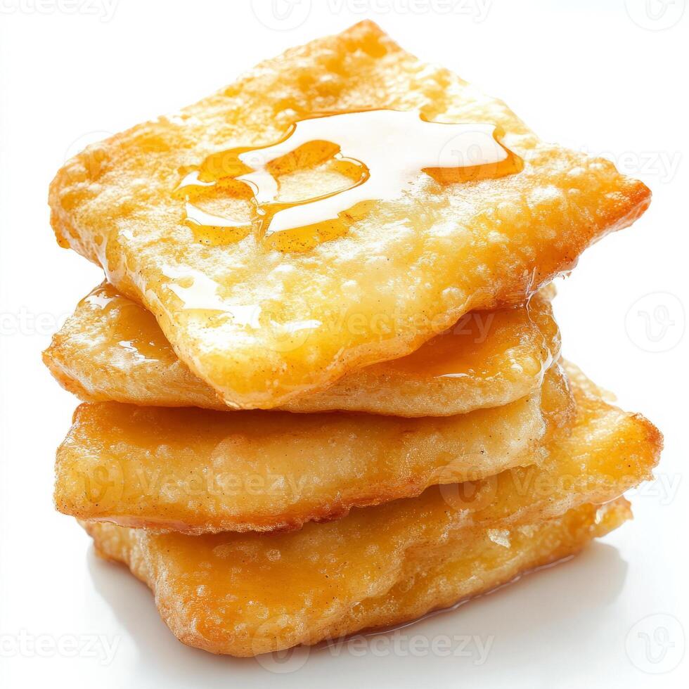 A stack of crispy waffles with honey on top photo