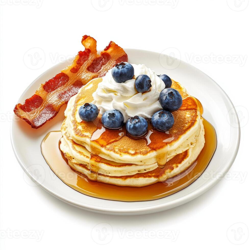 A plate of fluffy pancakes, topped with fresh blueberries, a drizzle of maple syrup, and a dollop of whipped cream, served with a side of crispy bacon. The pancakes, with their light and airy texture, photo