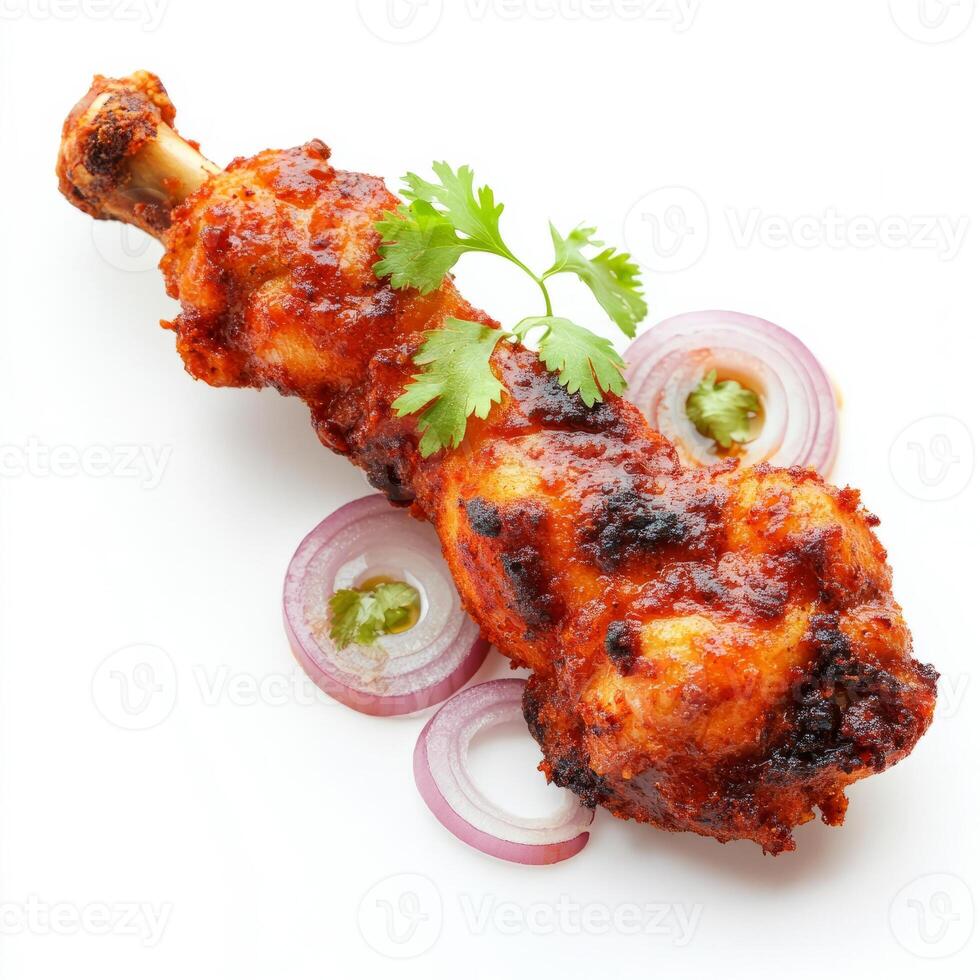 A close-up of a chicken lollipop, with a crispy chicken winglet, marinated in spices and deep-fried, served with schezwan sauce and onions, isolated on clean white background. photo