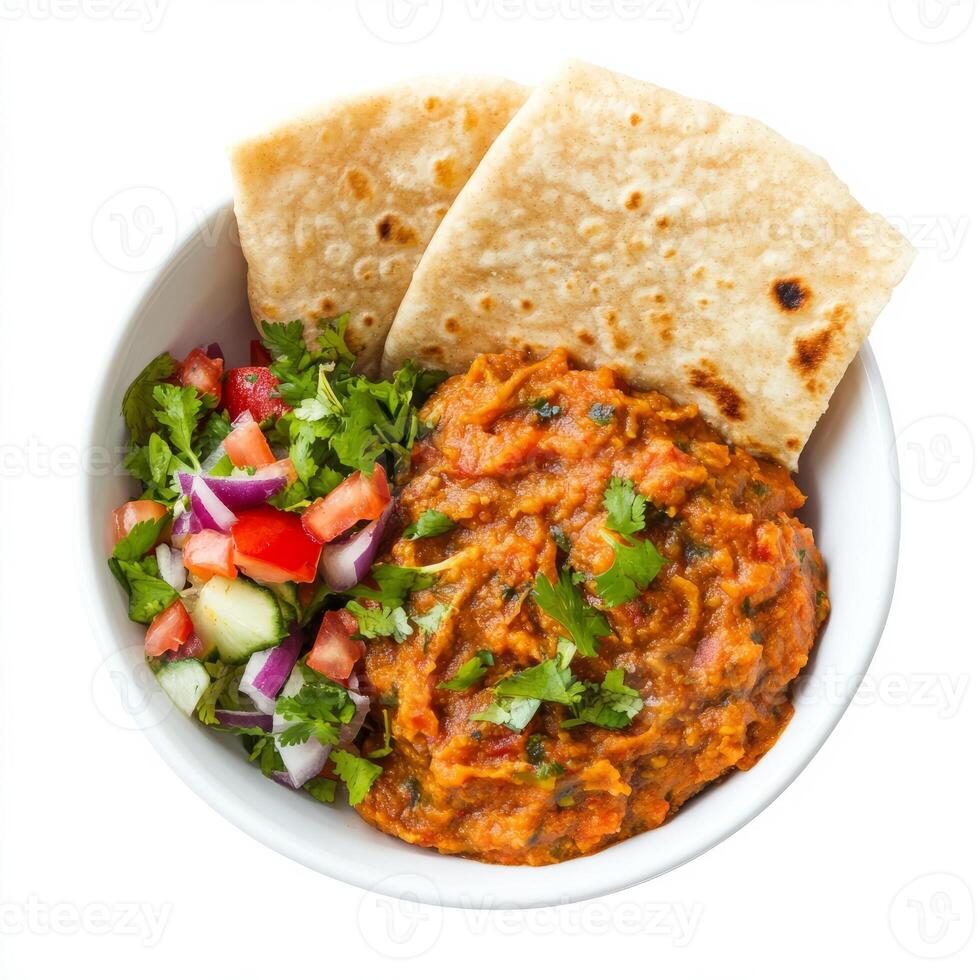 A bowl of baingan bharta, with roasted eggplant mashed and cooked with tomatoes, onions, and spices, served with roti and a side of salad, isolated on clean white background. photo
