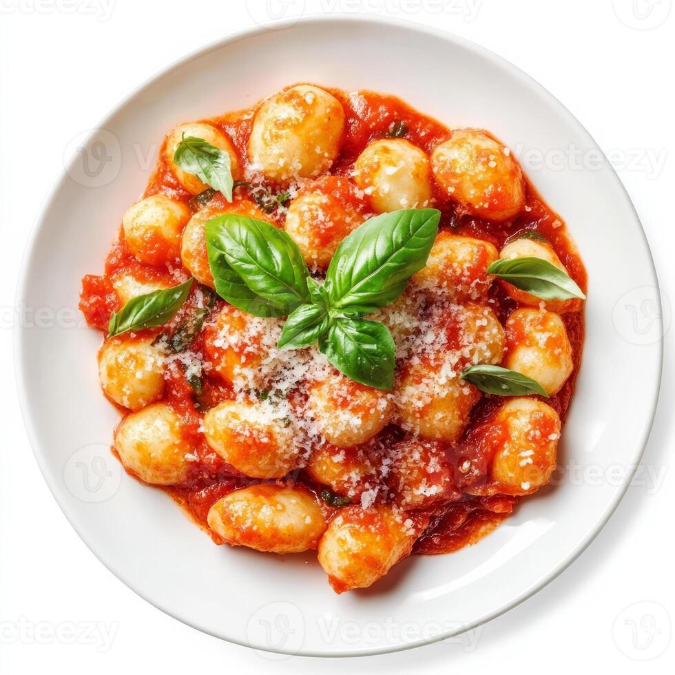 A plate of fluffy gnocchi, bathed in a rich tomato sauce and topped with fresh basil and Parmesan cheese. The gnocchi, with its soft, pillowy texture, offers a comforting Italian pasta dish. The photo
