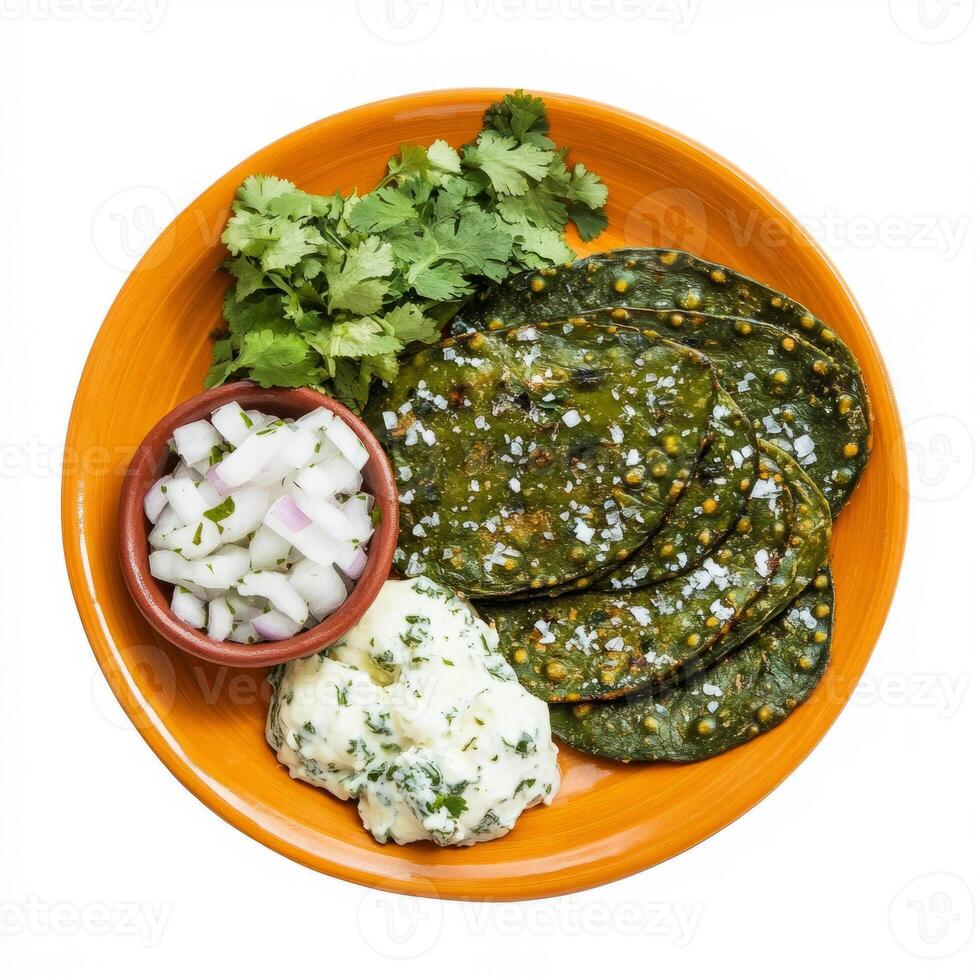 A vibrant plate of nopales asados, grilled cactus paddles, seasoned with salt and pepper, served with onions, cilantro, and a side of queso fresco, isolated on clean white background. photo