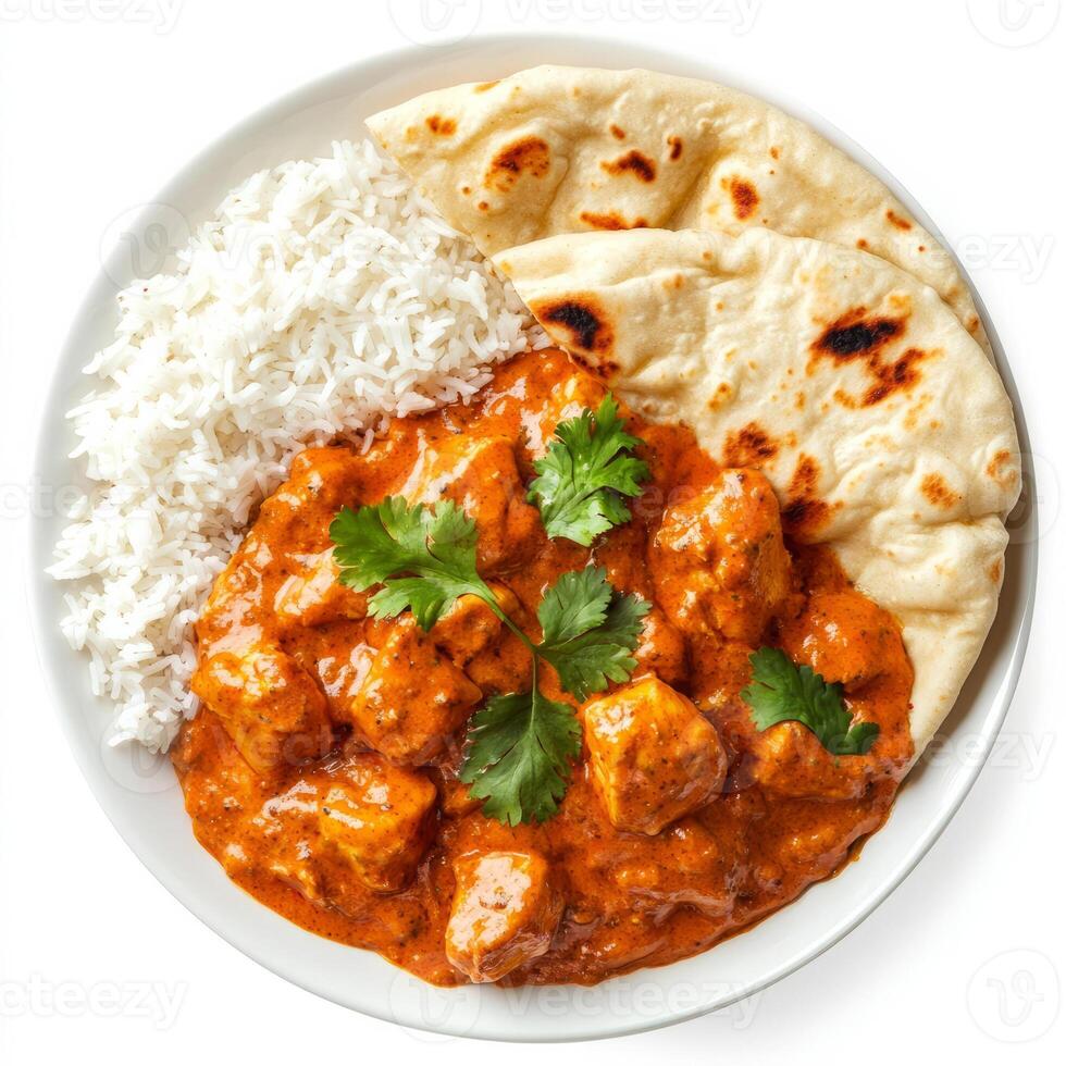 A beautifully arranged image of a plate of chicken tikka masala, featuring tender chicken in a creamy tomato sauce, served with rice and naan bread. The chicken tikka masala, with its rich, aromatic photo
