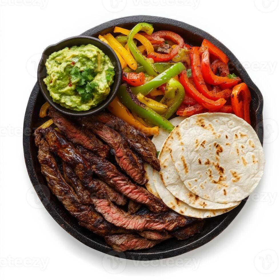 A sizzling fajita platter, with strips of marinated steak, bell peppers, and onions, grilled to perfection and served with warm flour tortillas and a side of guacamole, presented on a cast iron photo