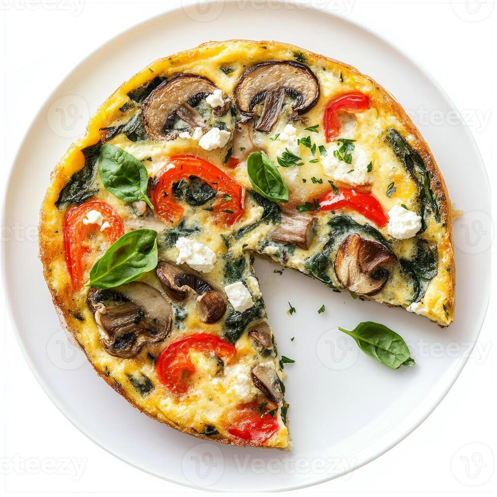 A quiche with mushrooms, spinach and cheese on a white plate photo