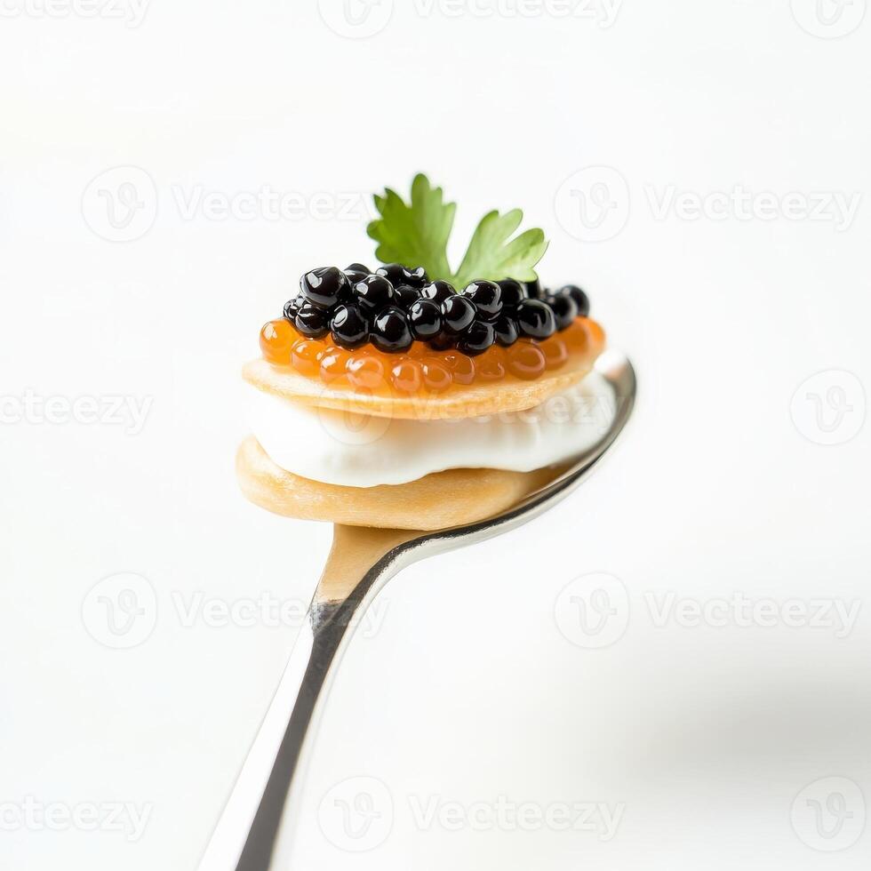 A spoon with a dessert on it with caviar photo