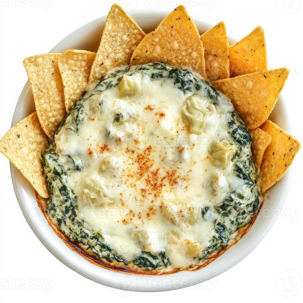 A bowl of creamy spinach and artichoke dip, served warm with crispy tortilla chips. The rich, cheesy dip is topped with melted mozzarella and a sprinkle of paprika for extra flavor. Isolated on clean photo