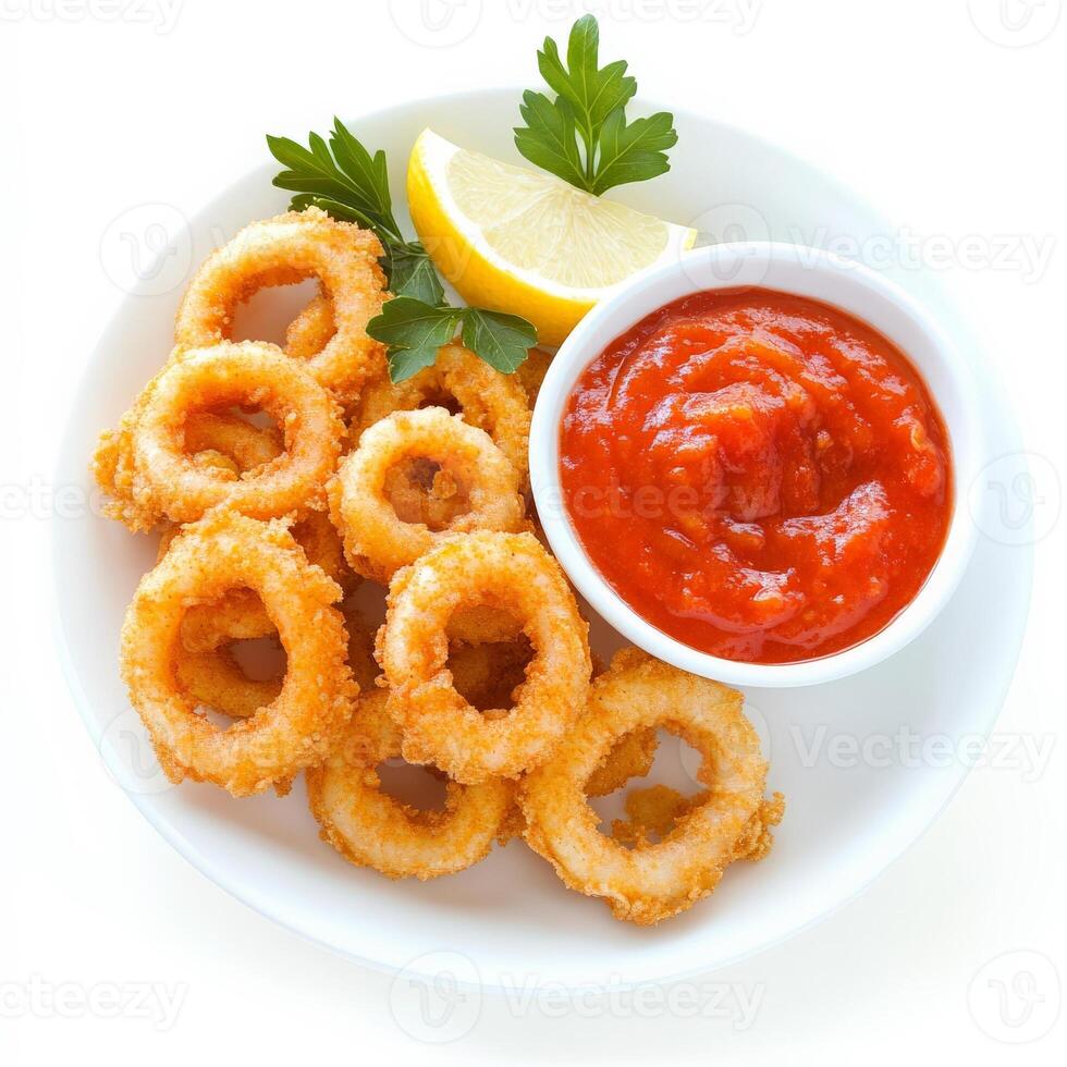 A plate of crispy fried calamari rings, served with a side of marinara sauce and a wedge of lemon. A delicious seafood appetizer. Isolated on clean white background photo