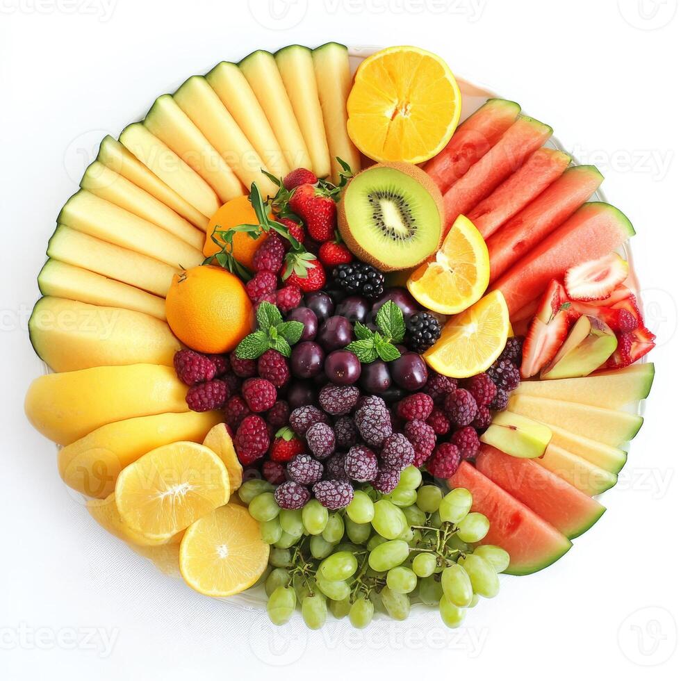 A colorful fruit platter with a variety of sliced melons, berries, grapes, and citrus fruits, arranged in an elegant and visually appealing manner. Isolated on clean white background photo