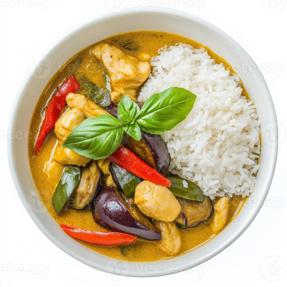 A bowl of vibrant Thai green curry, with tender chicken, eggplant, bell peppers, and fragrant coconut milk, served with steamed jasmine rice. The dish is garnished with fresh Thai basil. Isolated on photo
