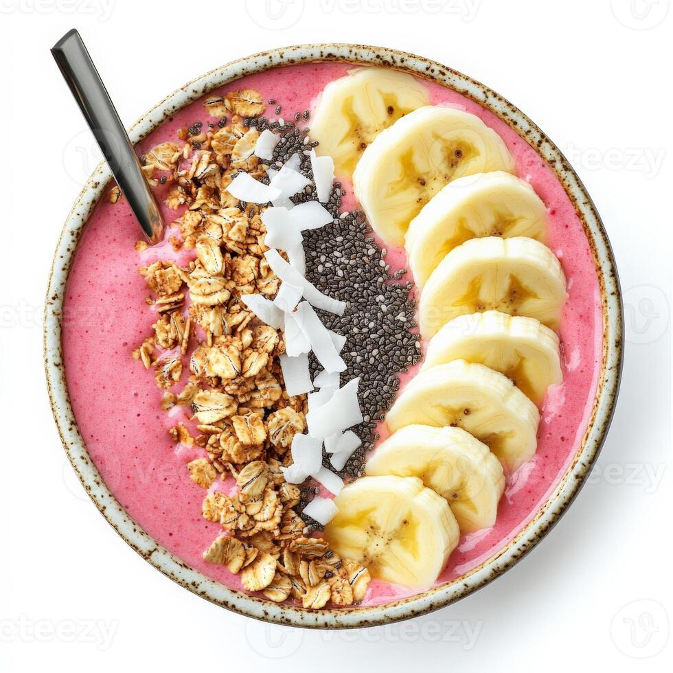 A colorful smoothie bowl made with blended tropical fruits, topped with granola, sliced bananas, chia seeds, and coconut flakes. A nutritious and visually appealing breakfast. Isolated on clean white photo