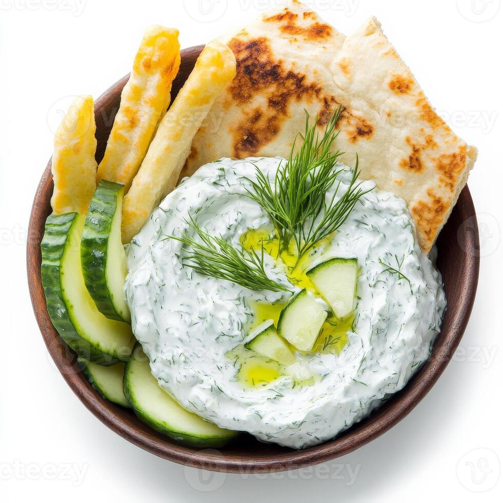 A refreshing Greek tzatziki dip, made with thick, creamy yogurt, finely grated cucumber, minced garlic, fresh dill, and a drizzle of extra virgin olive oil. Served with warm, toasted pita bread slices photo