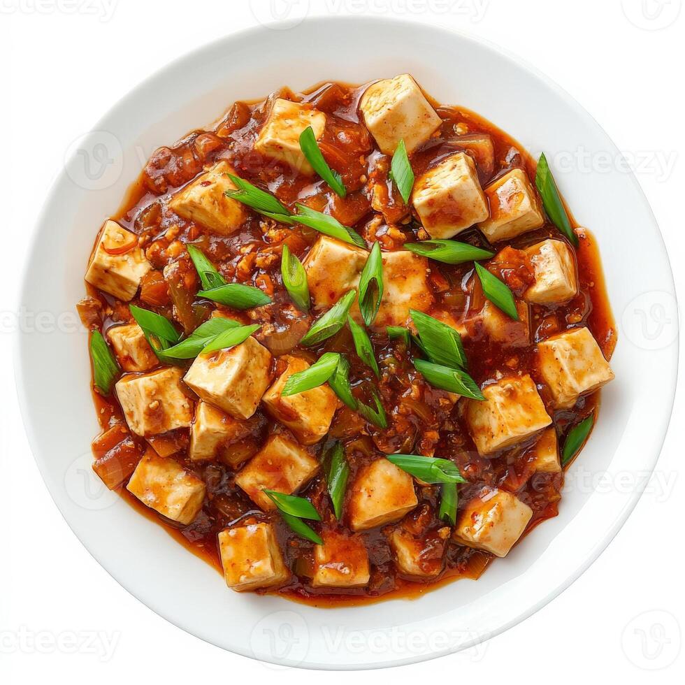 A plate of spicy Sichuan mapo tofu with soft tofu cubes in a rich, spicy chili and fermented bean sauce, garnished with green onions. A bold Chinese dish. Isolated on clean white background photo