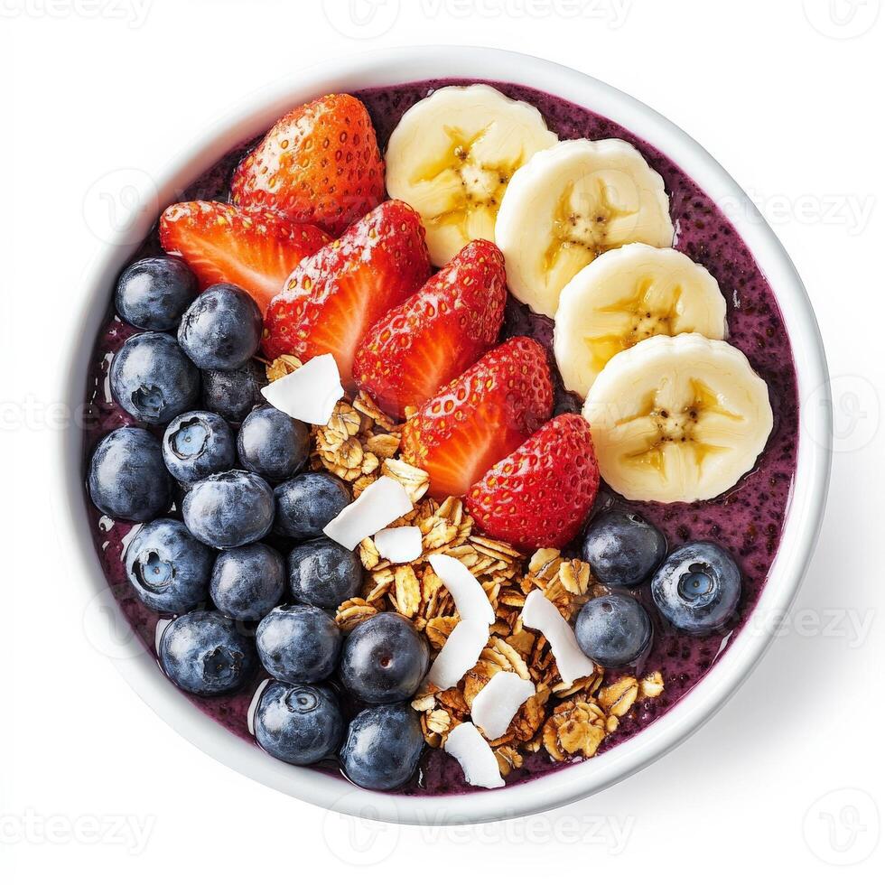 A vibrant acai bowl topped with fresh strawberries, blueberries, sliced bananas, granola, coconut flakes, and a drizzle of honey. A colorful and nutritious breakfast. Isolated on clean white photo