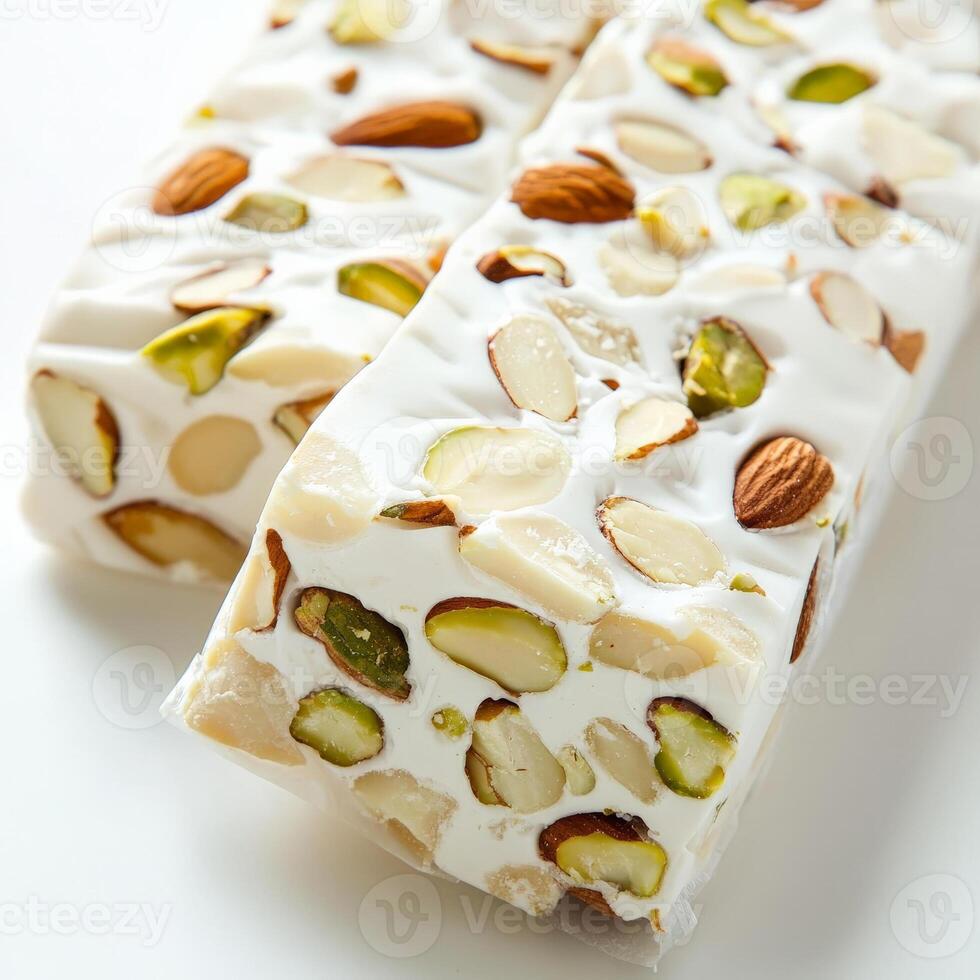 A close up of two pieces of white chocolate covered in nuts photo