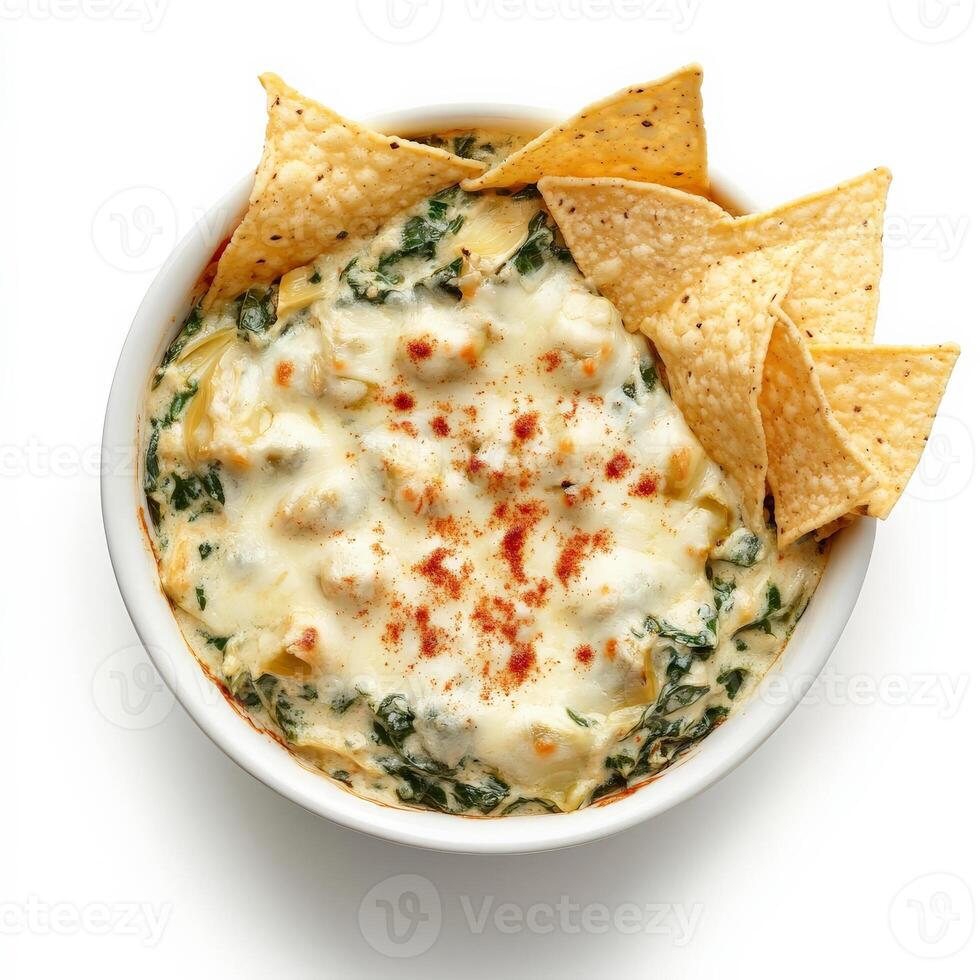 A bowl of creamy spinach and artichoke dip, served warm with crispy tortilla chips. The rich, cheesy dip is topped with melted mozzarella and a sprinkle of paprika for extra flavor. Isolated on clean white background photo