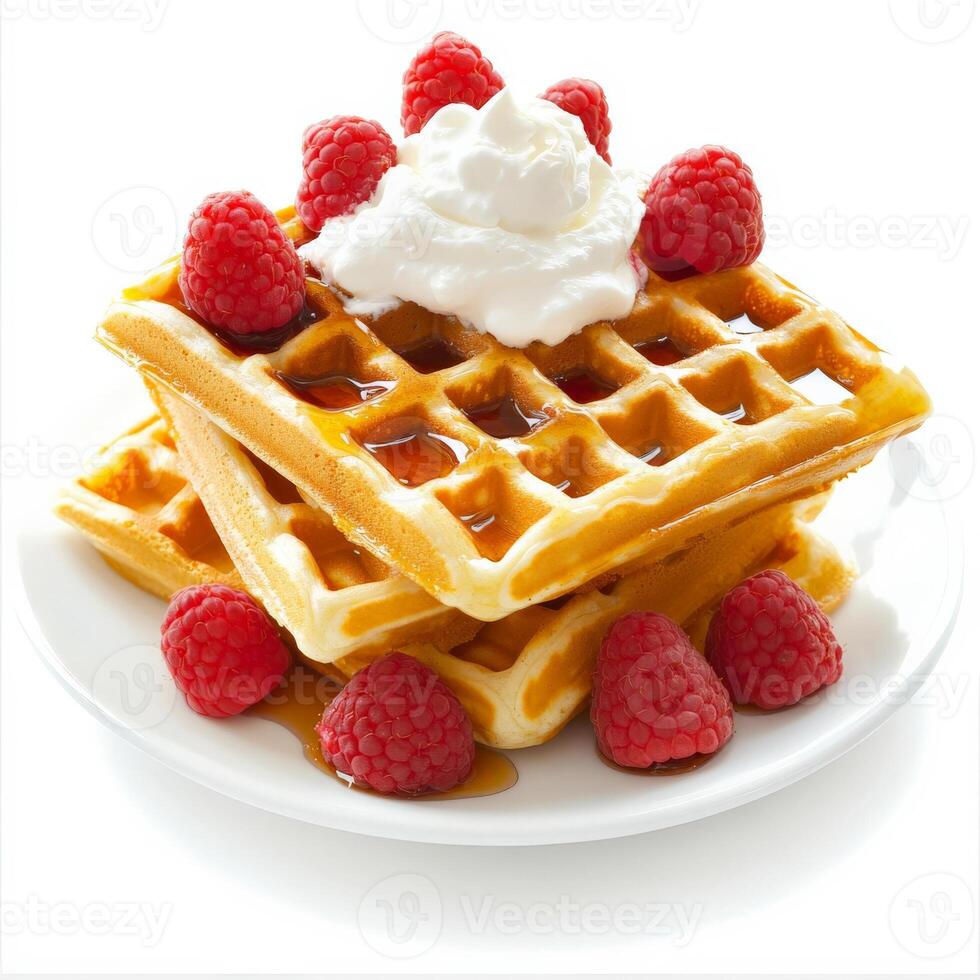 A plate of golden Belgian waffles, stacked high and drizzled with rich maple syrup. Fresh raspberries and a dollop of whipped cream add a sweet and tangy contrast. A perfect breakfast indulgence. Isolated on clean white background photo