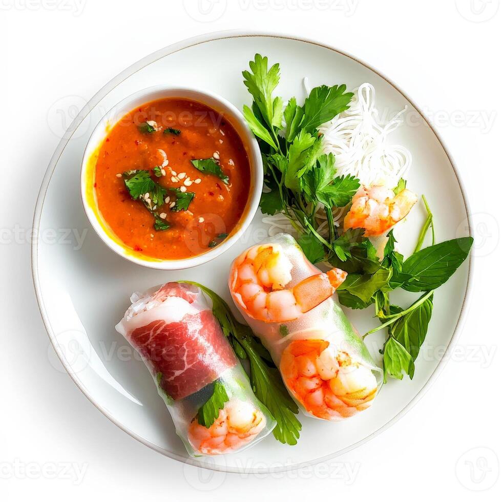 A plate with shrimp rolls, vegetables and sauce photo