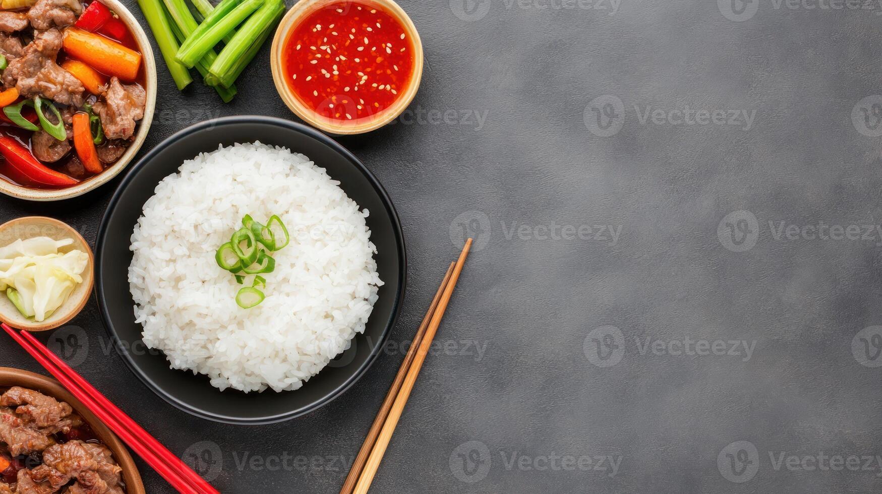 Asian food lay flat, rice bowl, beef stir-fry, and chopsticks with copy space for a restaurant menu photo