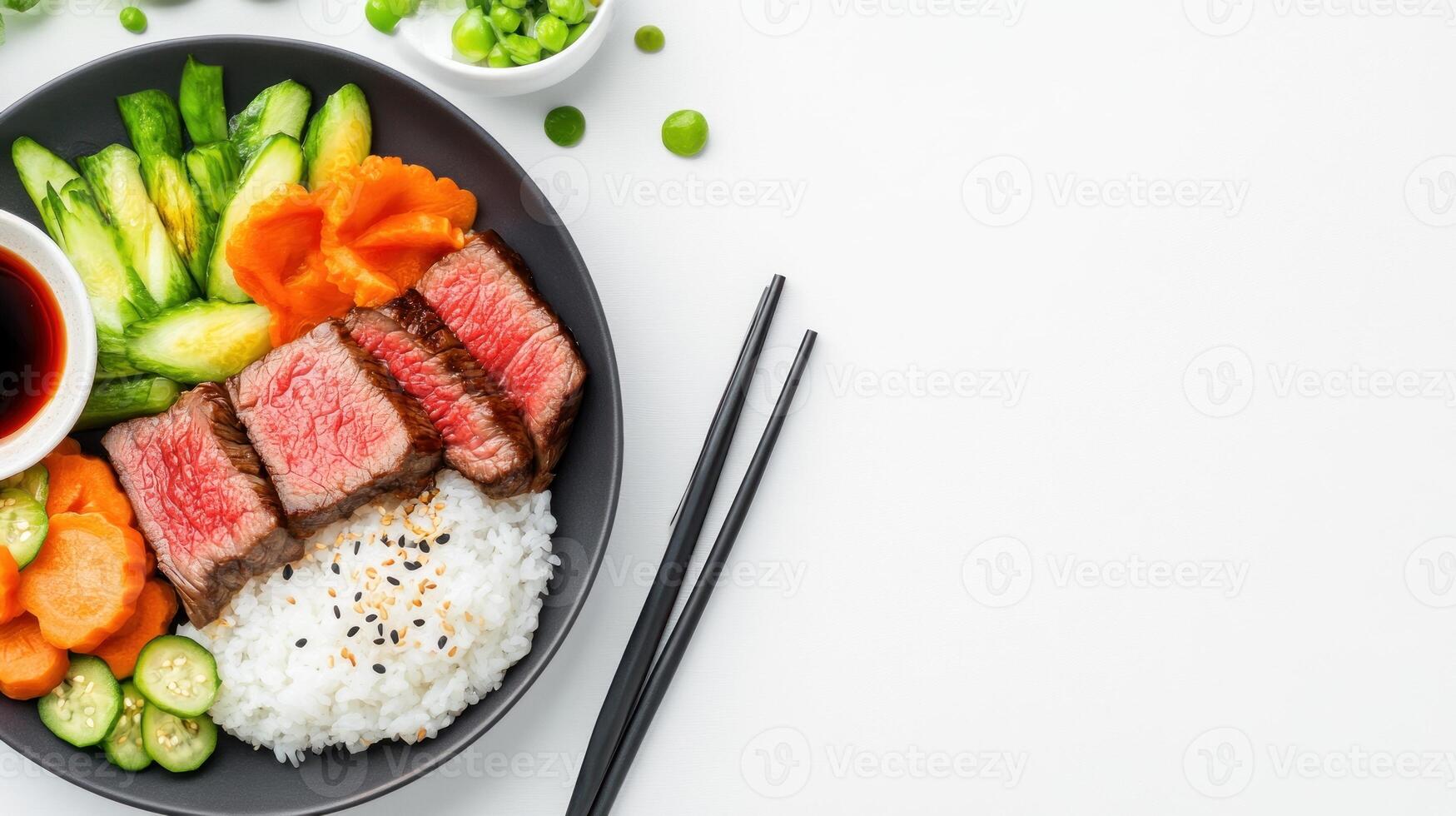 Balanced plate Medium steak slices, rice, carrots, cucumbers, and peas on a bright background. Use Editorial photo