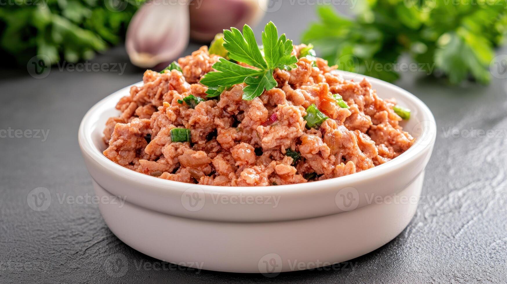 Bowl of ground meat on counter with parsley, garlic and herbs. Potential use cookbook photo