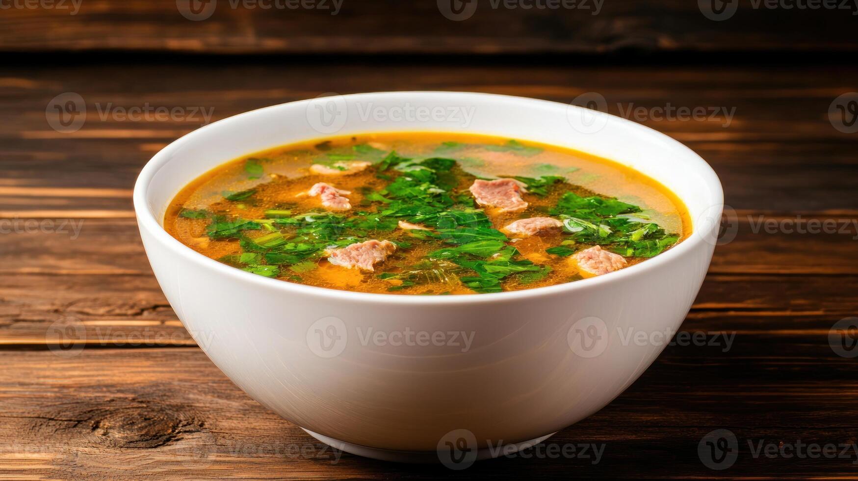 Broth with meat greens, delicious soup served on wooden table, ideal for menu use or food blogging photo