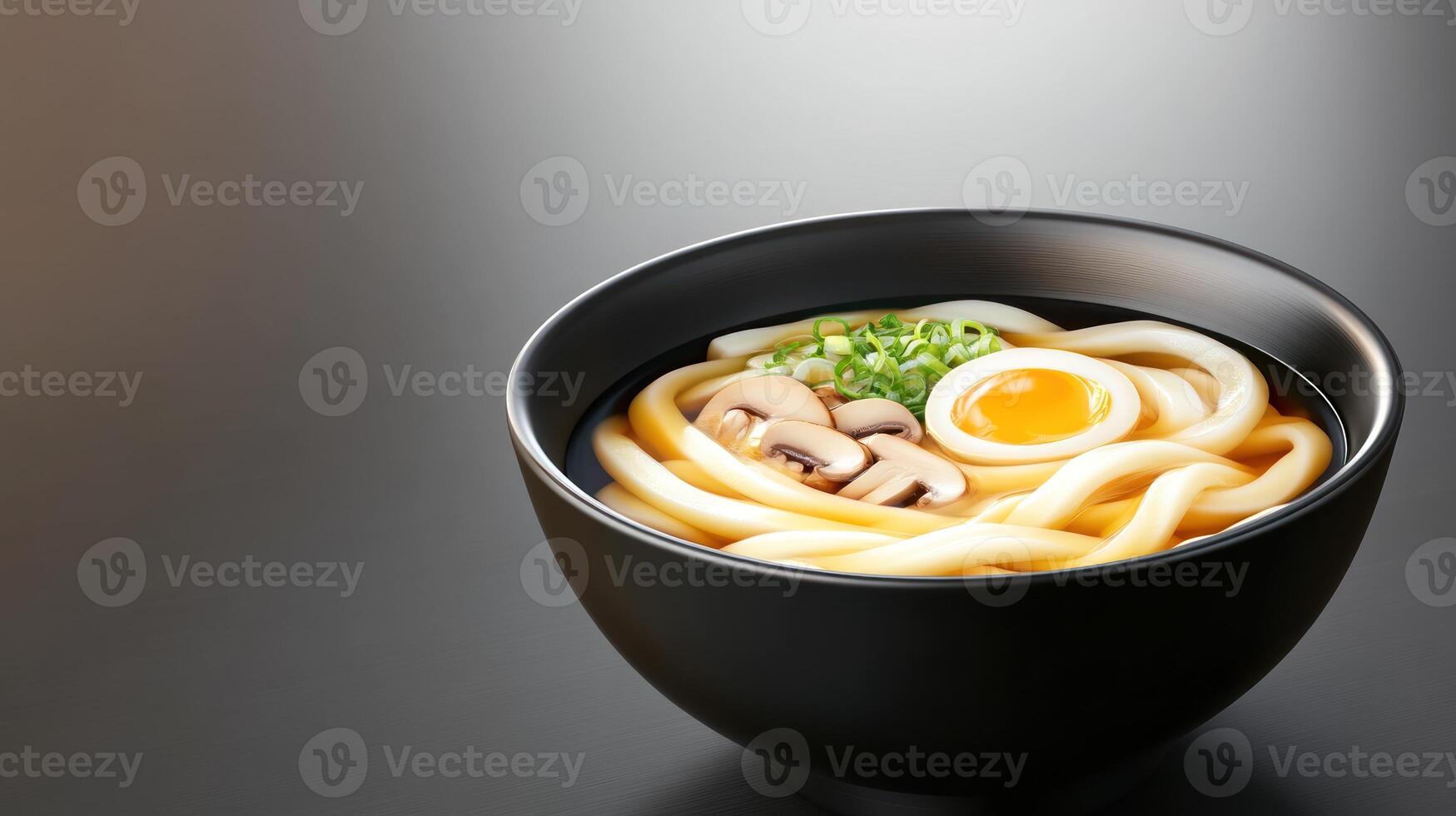 Delicious udon noodle soup with egg and mushrooms in a black bowl. For a restaurant menu photo