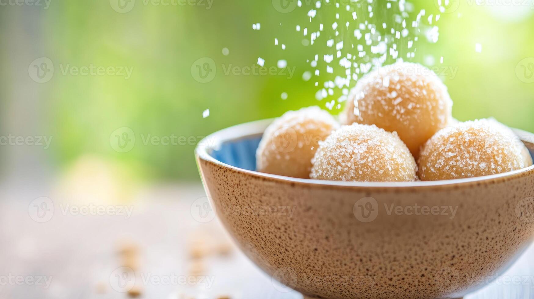 Dessert being sprinkled in a bowl on a table. Green nature background. Food photography photo