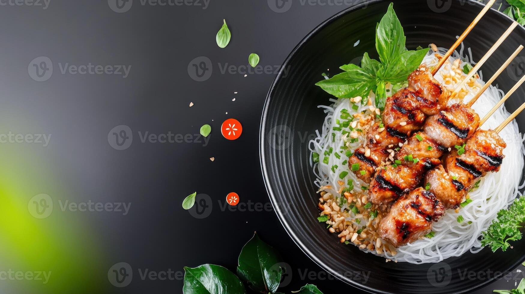 Grilled meat skewers on rice noodles in black bowl. Restaurant menu or food blog use photo