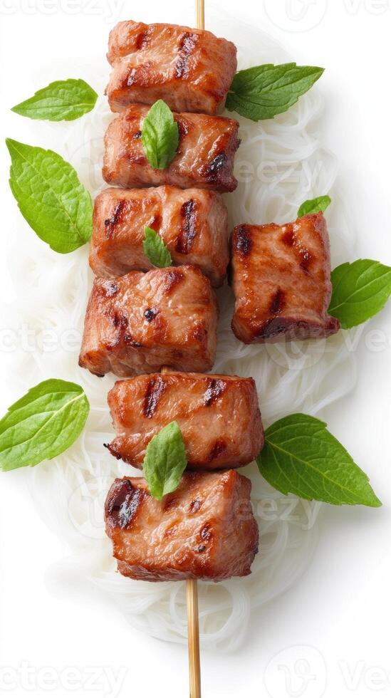 Grilled beef kebab with basil leaves on noodles for lunch, a tasty, and fresh diet meal photo