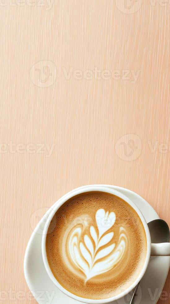 Latte art in cup on peach surface for menu and social media photo