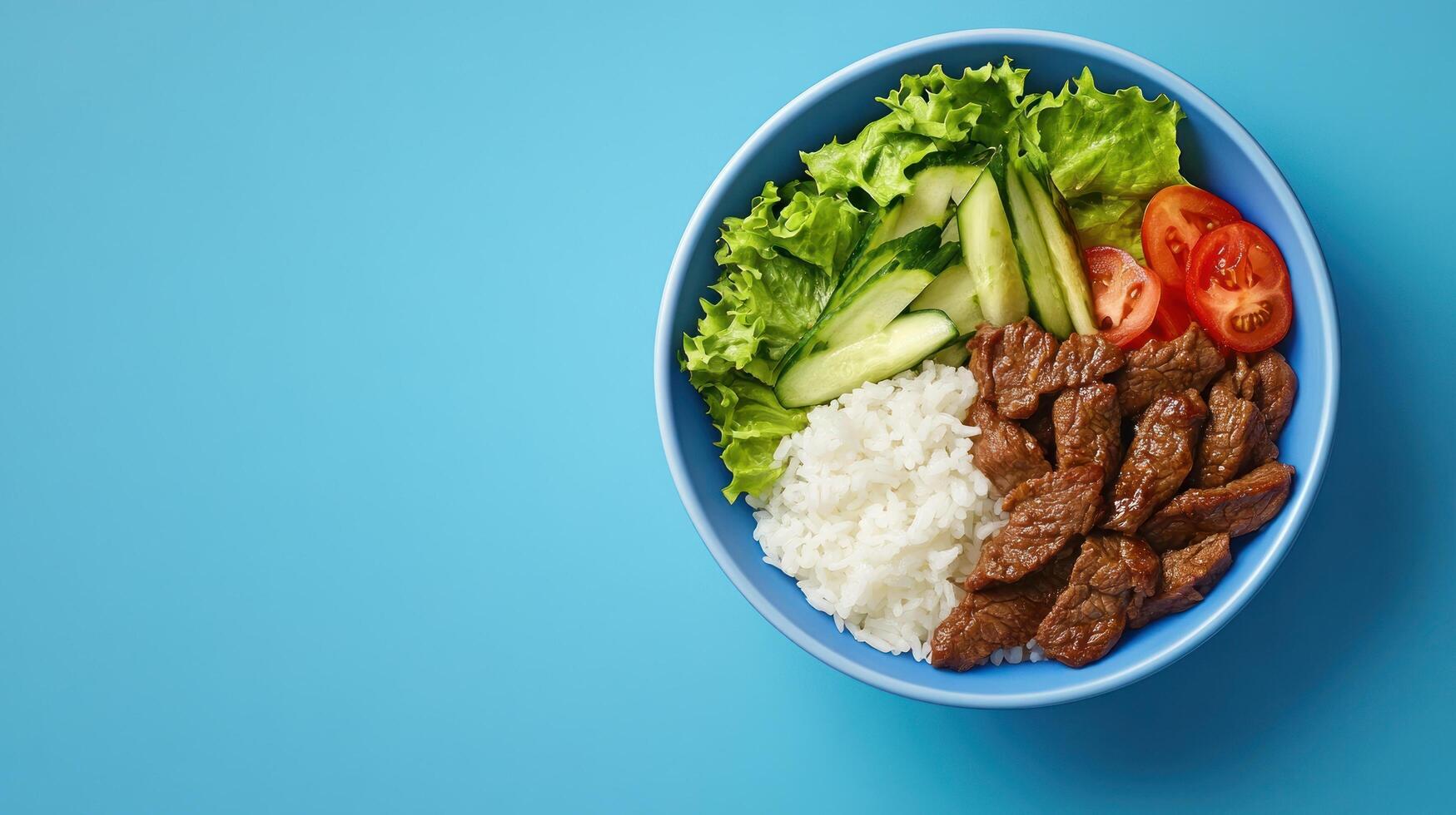 Meat and rice bowl with fresh vegetables is ready to be served. Can be used as part of a meal plan photo