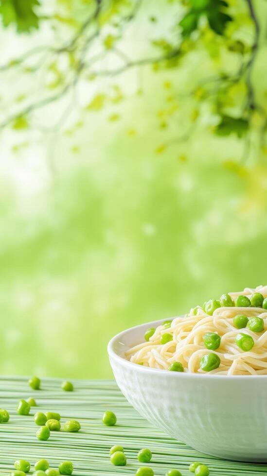 Noodles with peas in a bowl on a wooden table, foliage background, could be used for a cook book cover photo