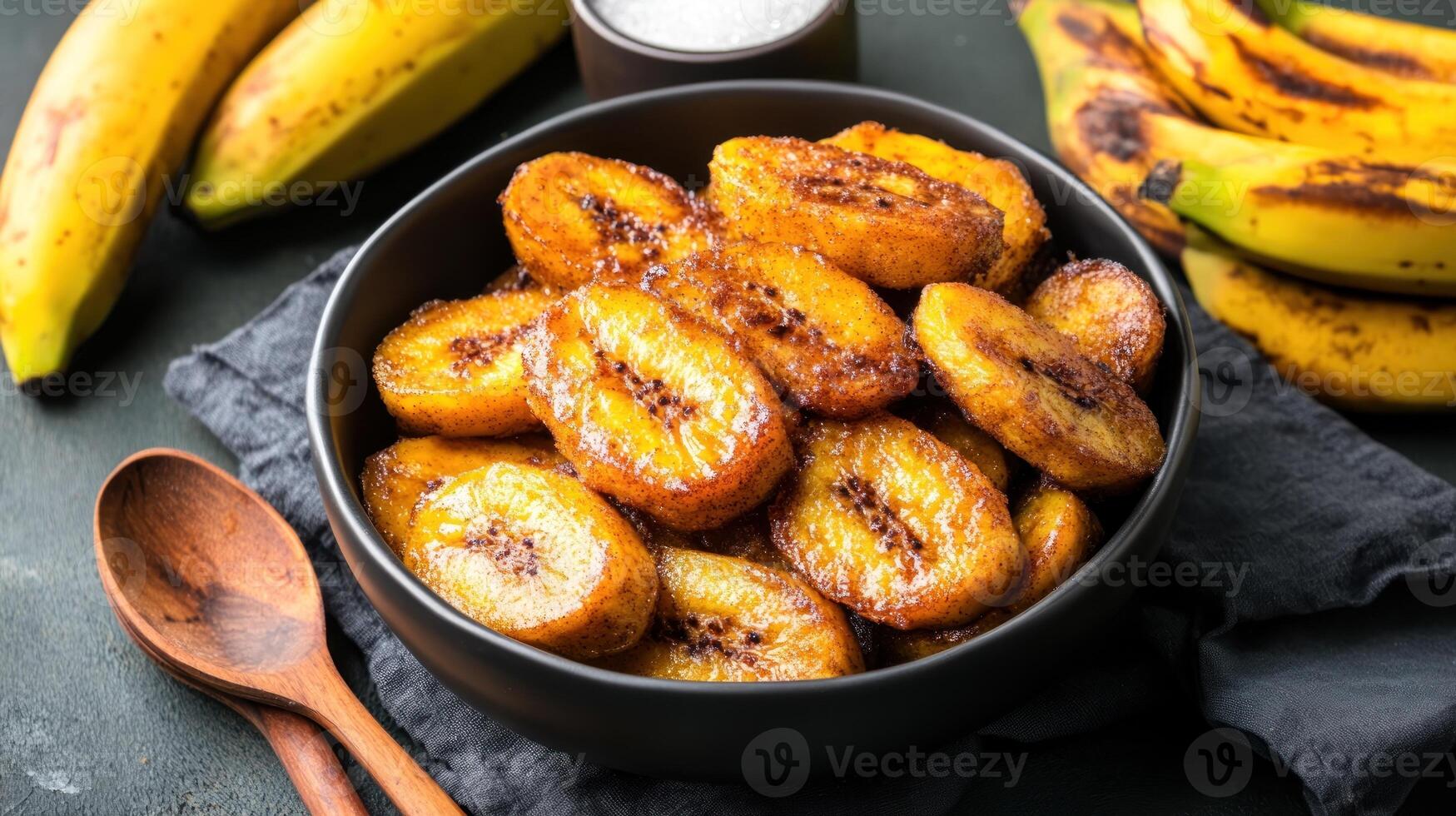 Plantain snack fried in a bowl on table with fruit ideal for snack or dessert menu ads photo