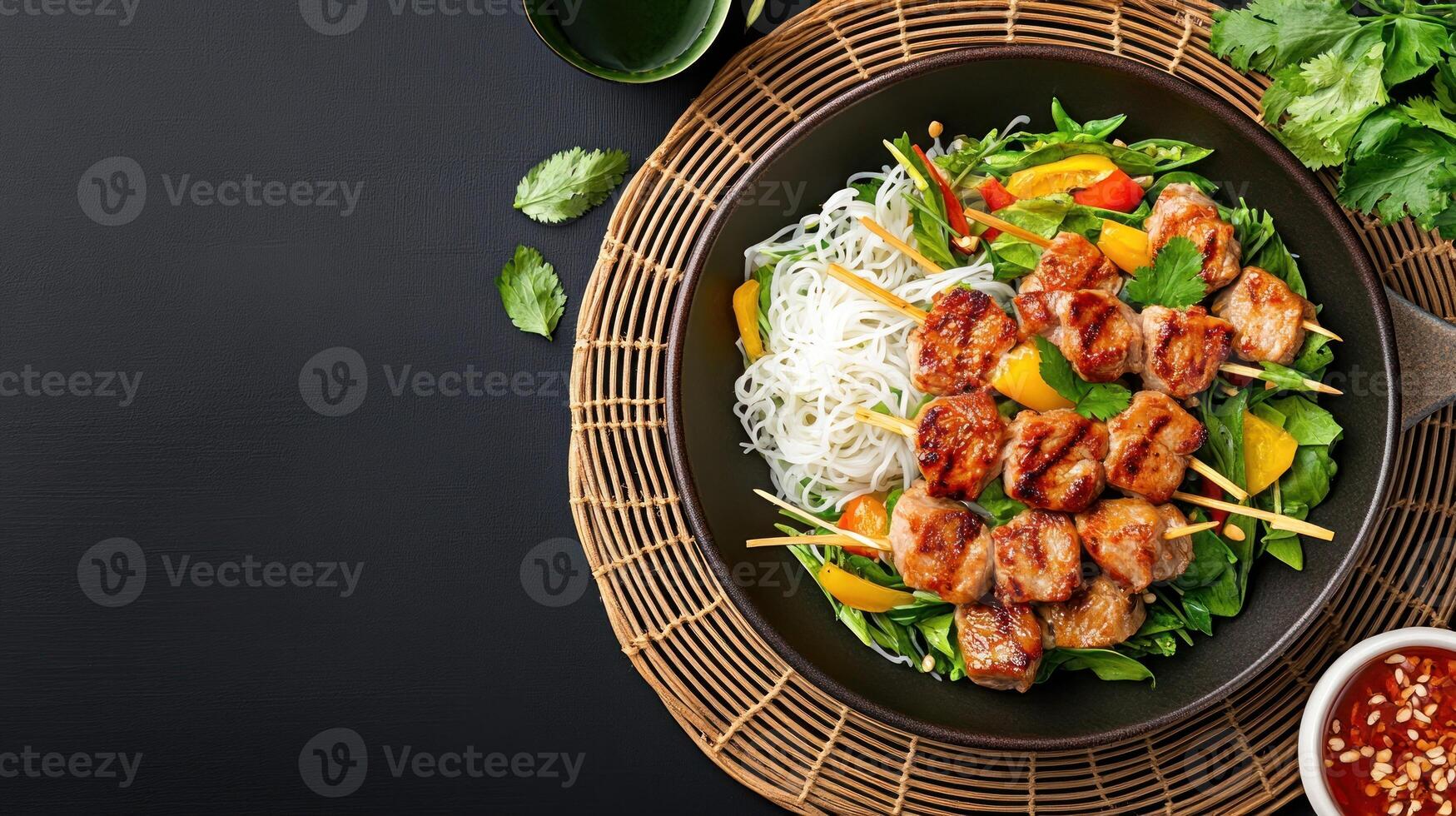 beef skewers on rice noodles with veggies for lunch in bowl on a mat. Recipe ad photo
