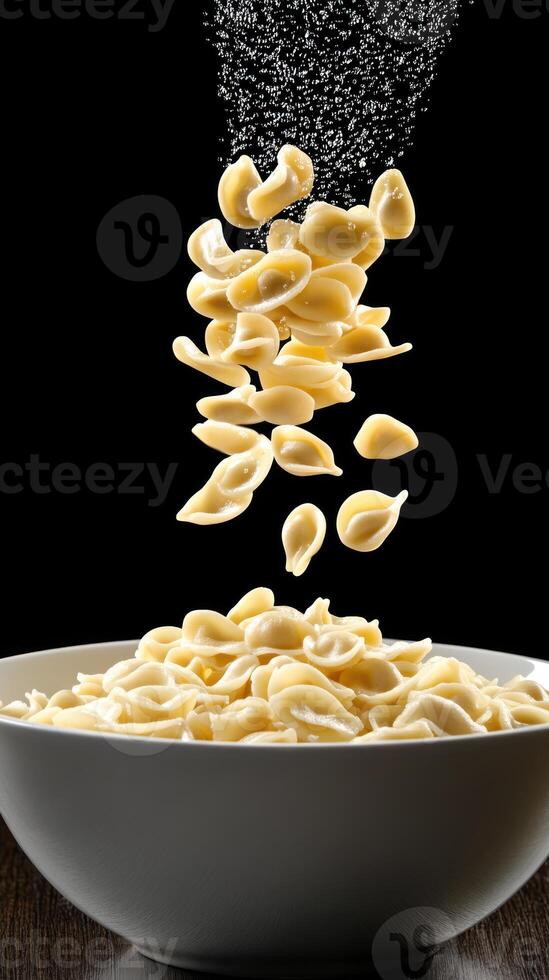 Pouring pasta into bowl on wood, creating a fresh, ready-to-cook meal for healthy eating photo