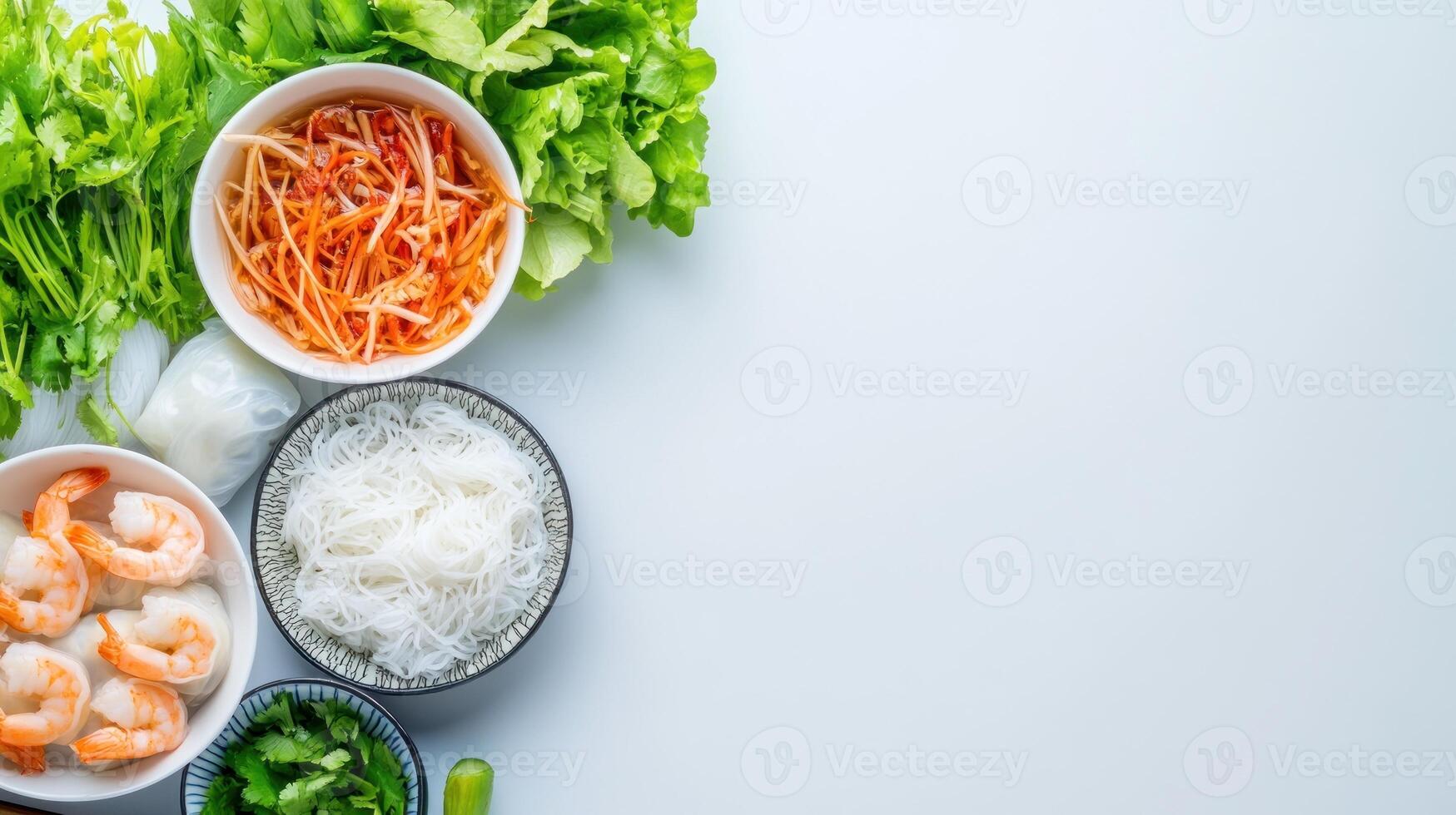 Preparing fresh spring rolls shrimp, rice noodles, greens on a white surface. Healthy eating photo