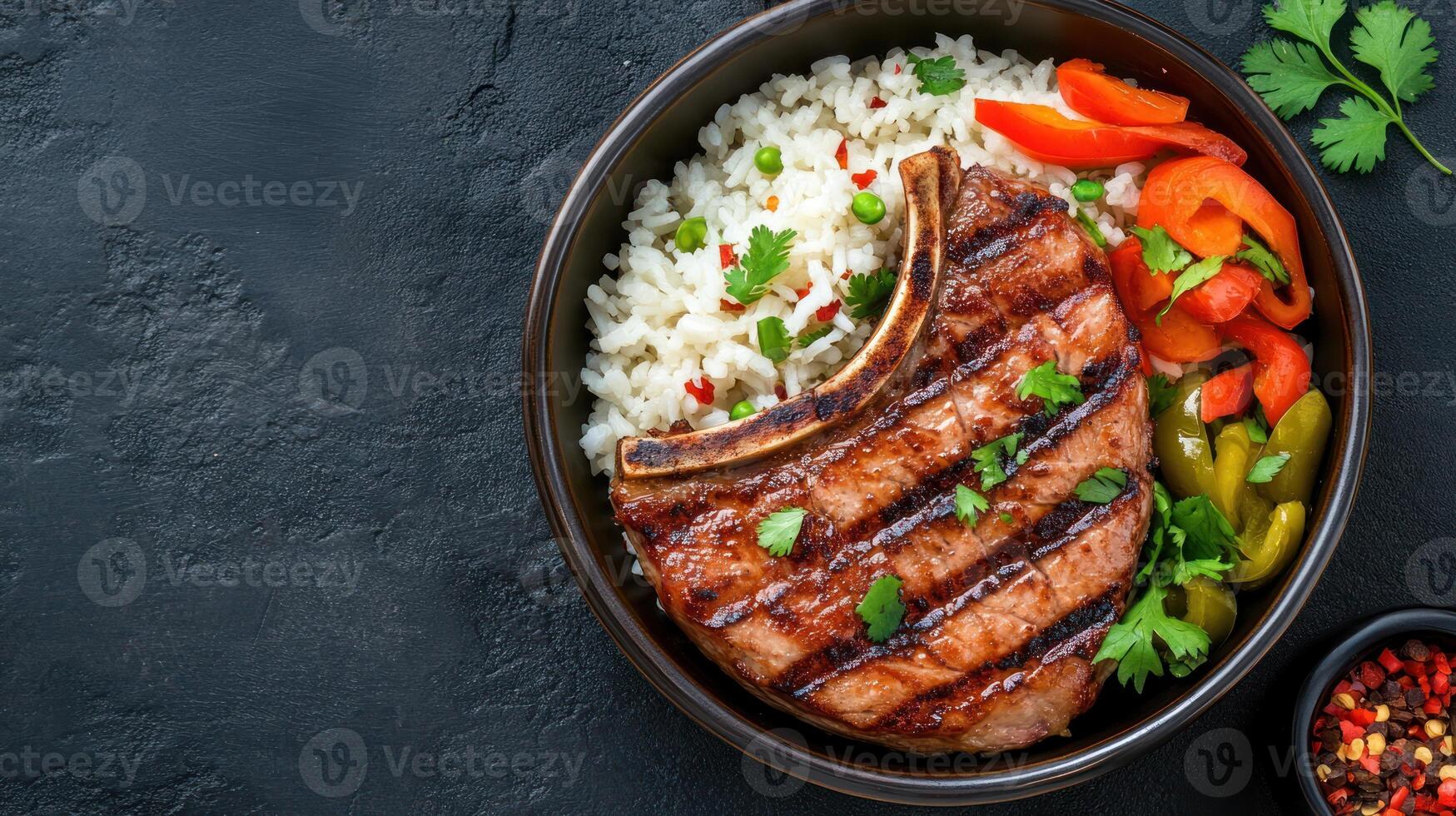 Roasted beef chop dish with rice and peppers, healthy meal for lunch on dark textured background photo