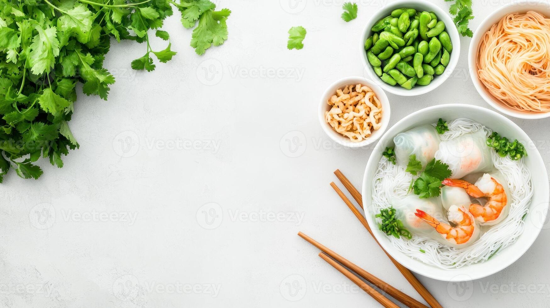 Shrimp spring rolls with noodles, herbs, and dipping sauces, on white textured surface photo