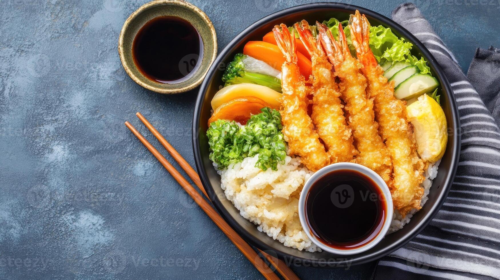 Shrimp tempura with veggies on rice in bowl. Soy sauce, chopsticks near napkin, advert photo