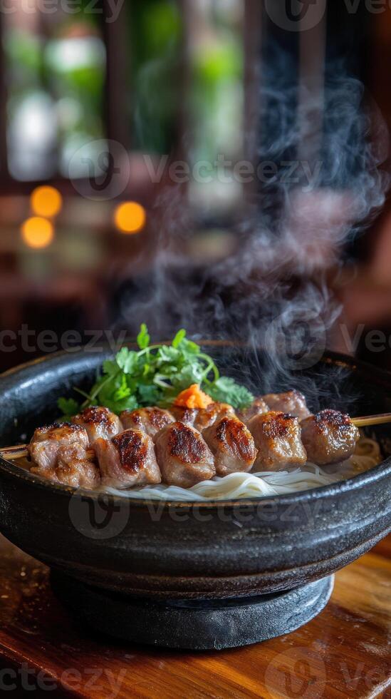 Skewers with noodles steaming hot on a wooden table with a blurry outdoor view photo