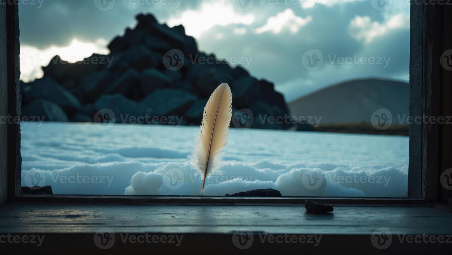 Feather Resting on Window Sill Overlooking Snowy Landscape Scenery photo