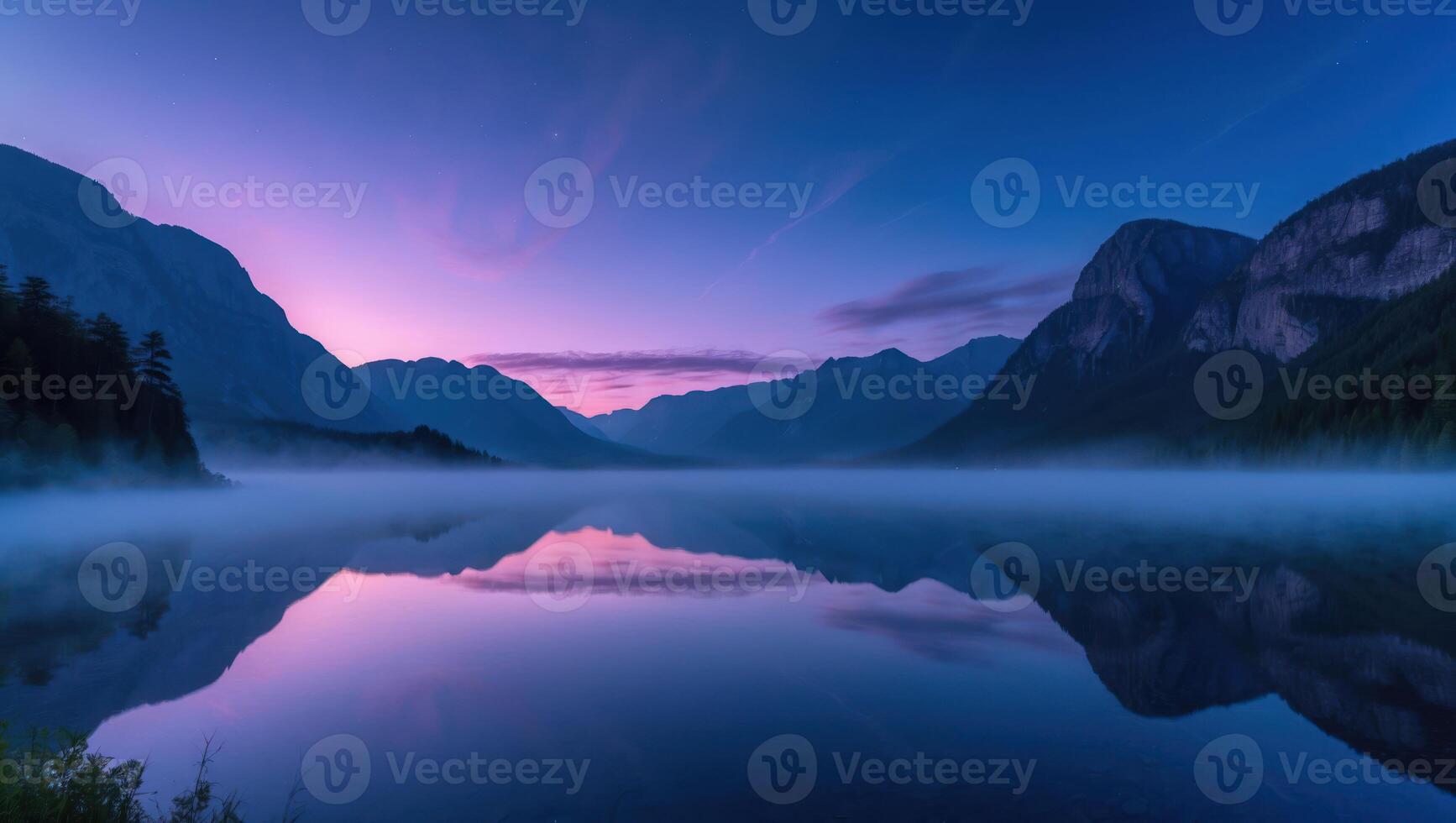 Reflecting Mountain Lake Landscape at Dusk with Mist and Calm Water photo