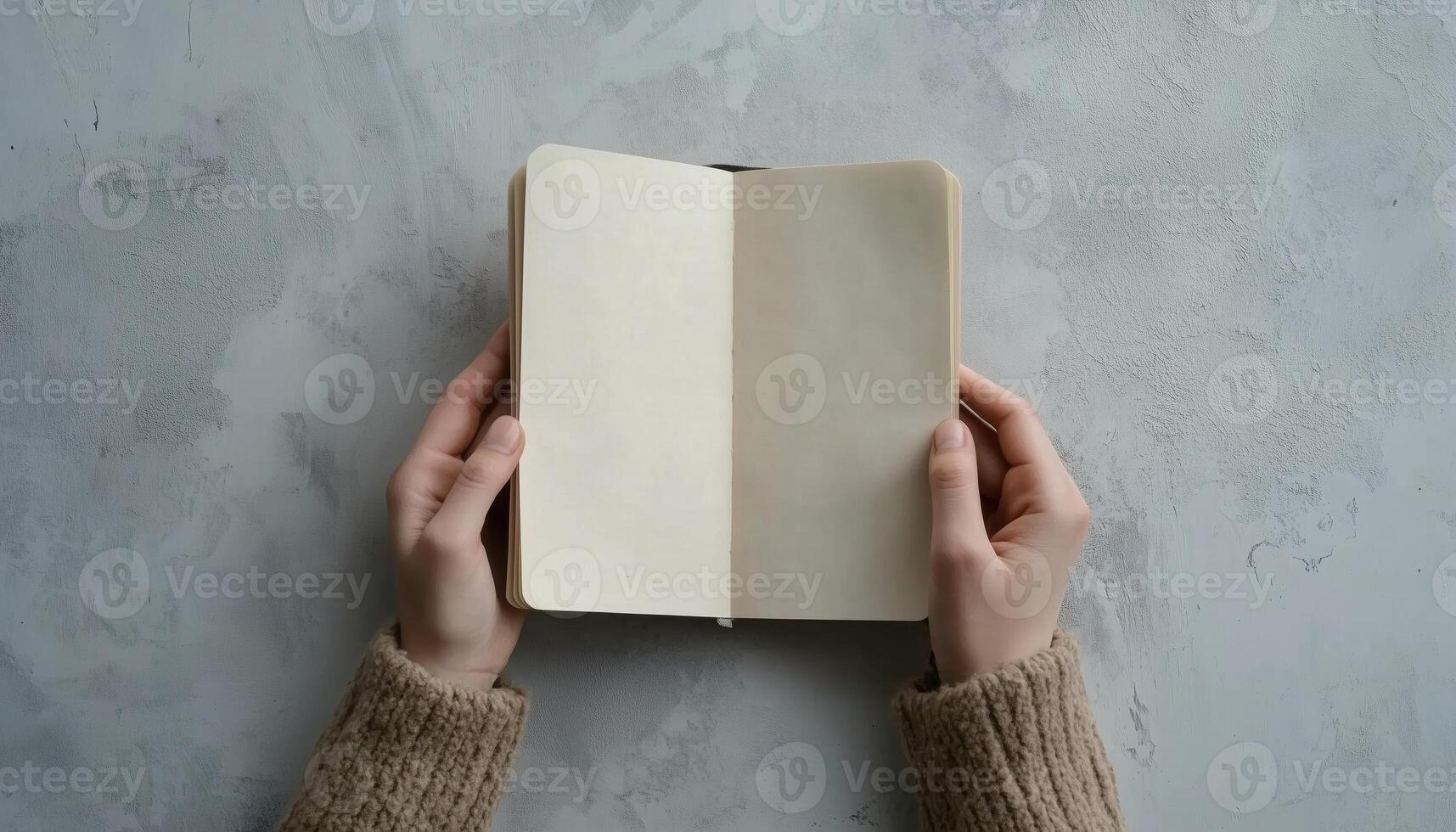 Top View Image Of Woman Holding Blank Notebook On Light Grey Table For Mockup Design With Empty Pages For Inserting Text Or Images photo