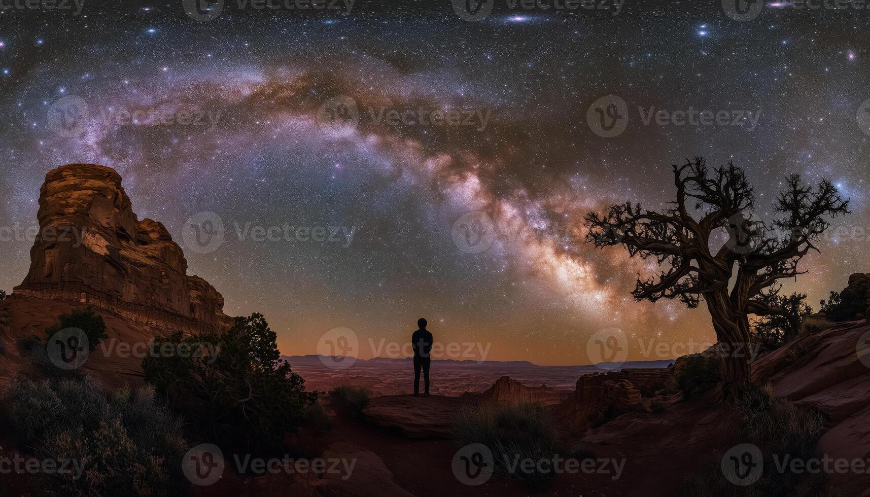 Silhouette Of A Person Standing Beneath The Vast Milky Way In The Utah Desert, Showcasing The Serene And Majestic Night Landscape Of The Usa photo